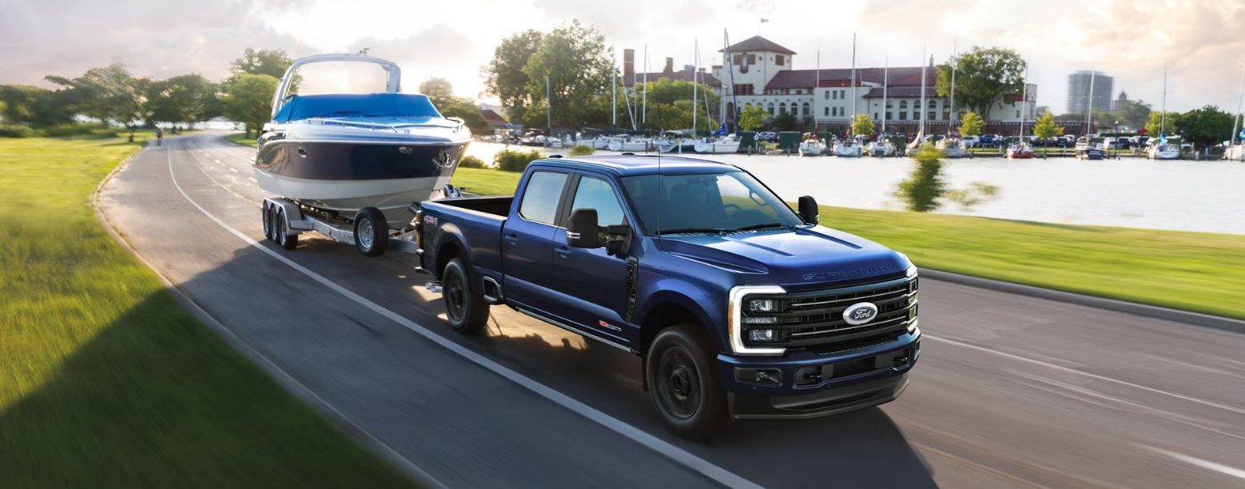 Blue 2026 Ford F-250 SuperDuty towing a boat